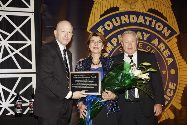 Denise McCabe and Bruce Bartlett accept Lifetime Achievement Award for Bernie McCabe from Tampa Bay Area Chiefs of Police Association